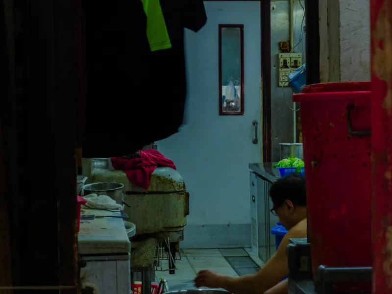 A crowded Hong Kong shop interior, goods stacked from floor to ceiling
