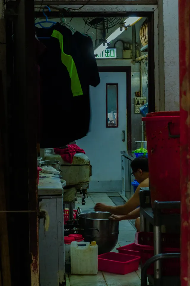 A crowded Hong Kong shop interior, goods stacked from floor to ceiling