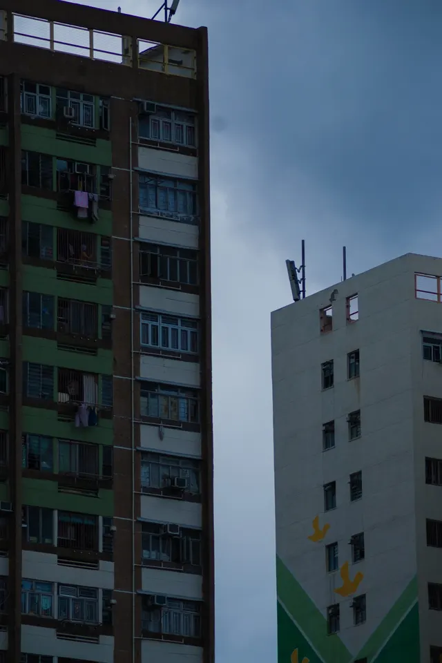 A tower block against a heavy grey sky